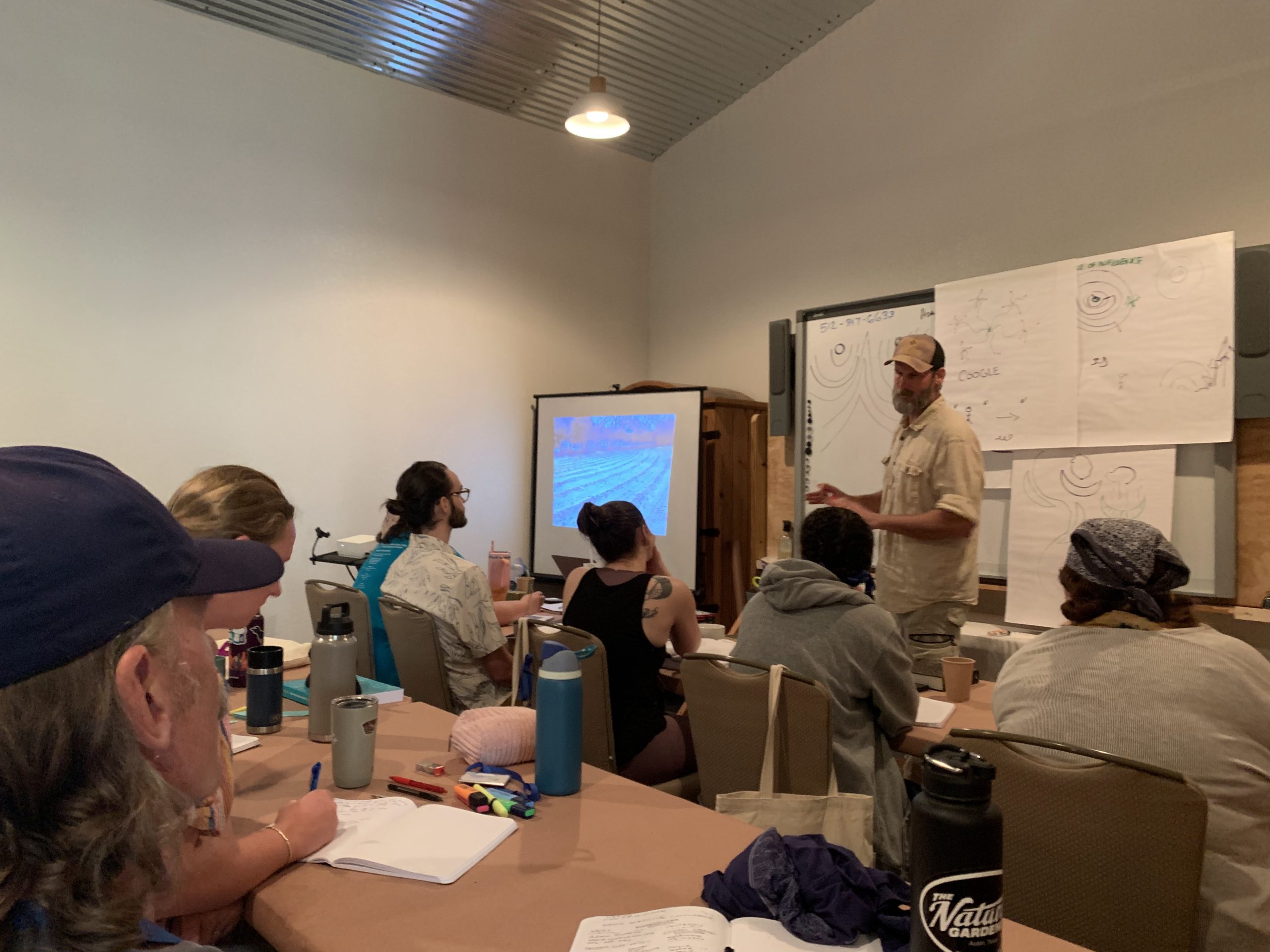 Adam Russell teaching permaculture in the classroom at lotus ranch retreat center in Wimberley, TX.